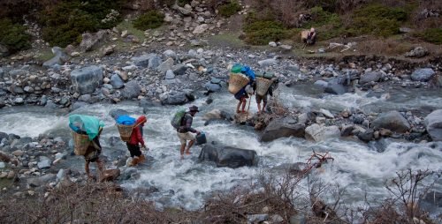Tsum Valley Trek picture of locals crossing stream